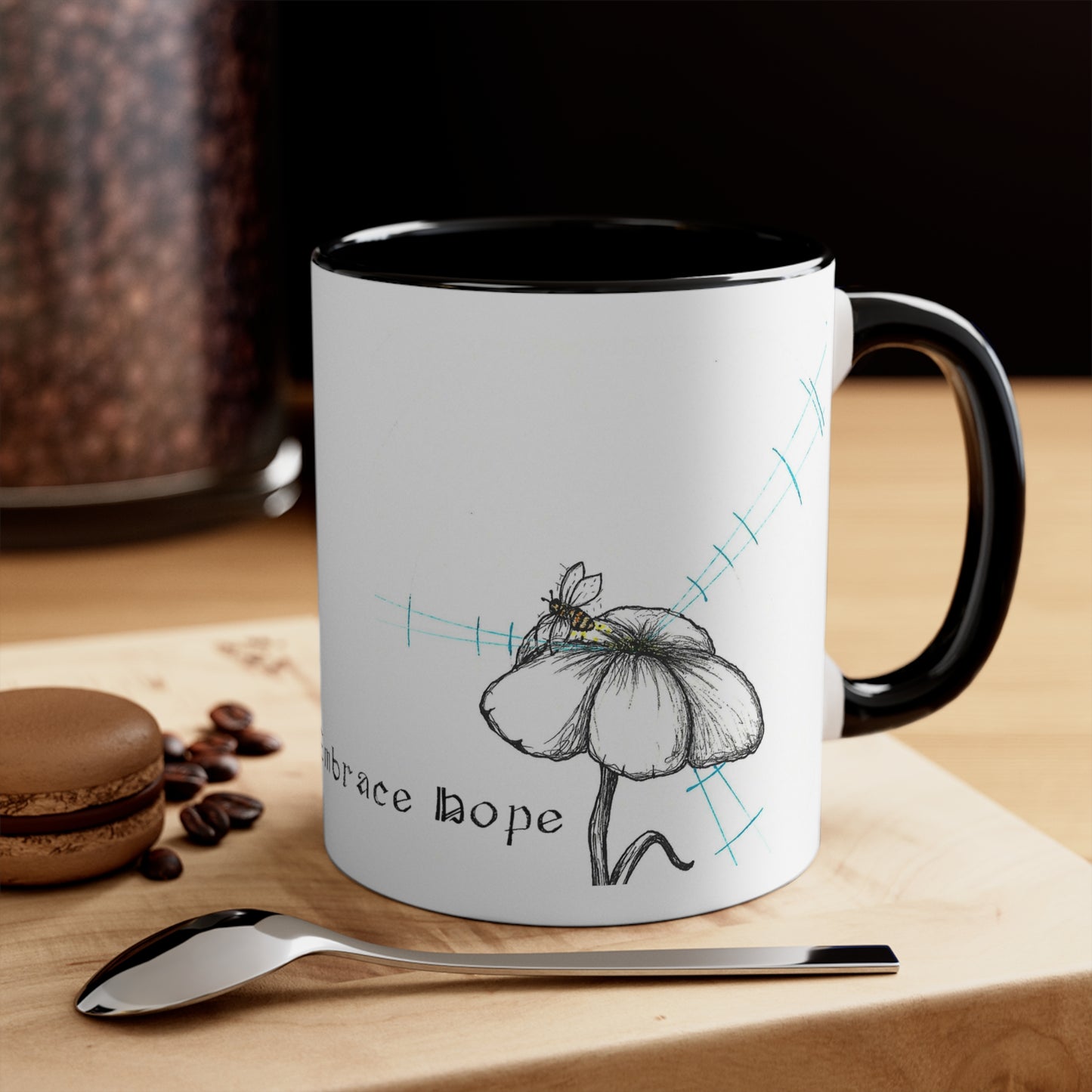 White Coffee Mug, black Inside, black handle, Reject Certainty Embrace hope text, flower and bee image, sitting on a table