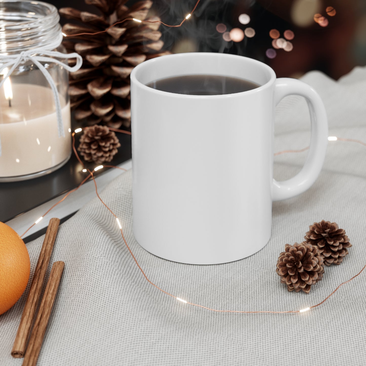 white coffee mug on table with pine cones